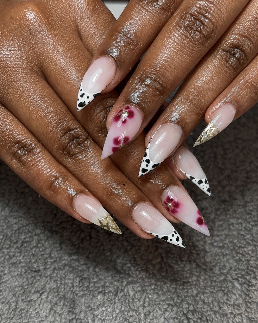 Stiletto nails with cow print and hand-painted flowers